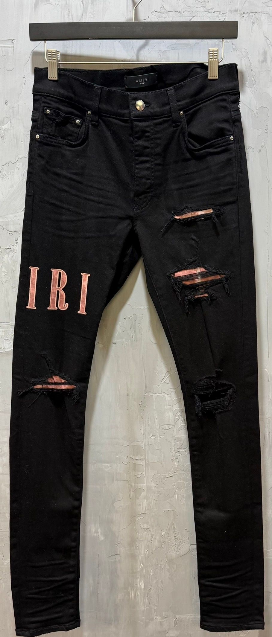 waxed logo-appliqué skinny jeans